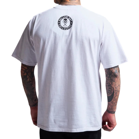 White t-shirt with a logo on the back worn by a person with tattoos.