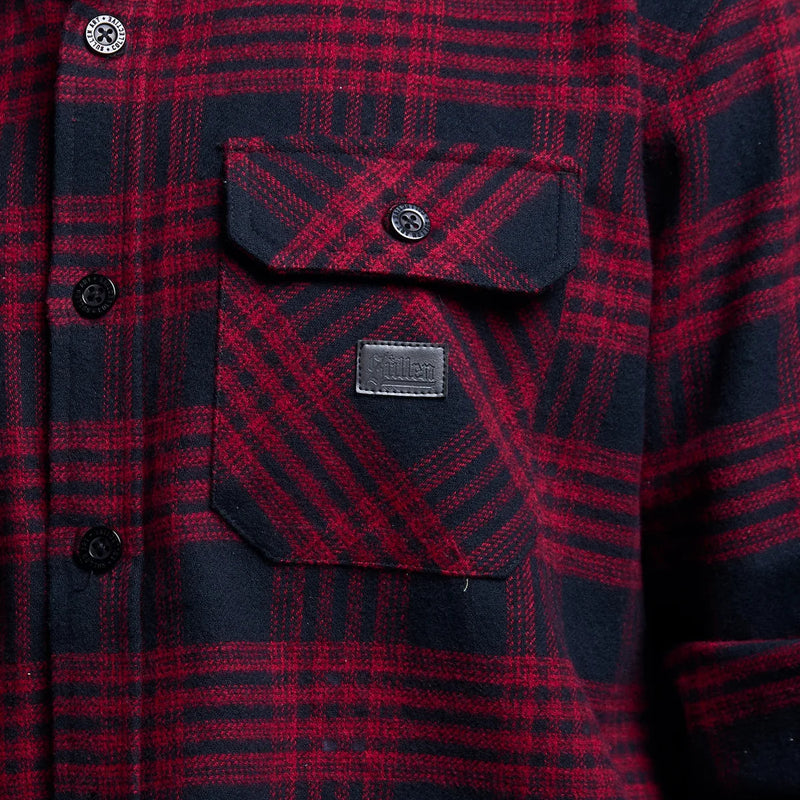 Load image into Gallery viewer, Close-up of a red and navy plaid flannel shirt with a chest pocket and a small leather brand patch reading 'SULLEN'.
