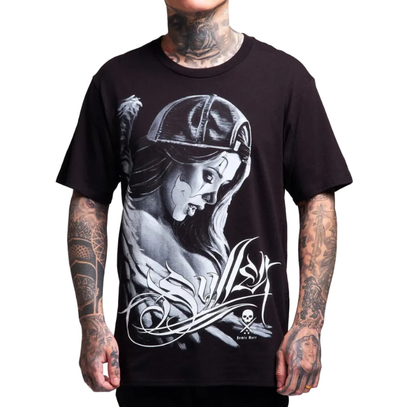 Load image into Gallery viewer, A black short-sleeve graphic t-shirt featuring a large white and gray illustration of a woman in a cap, worn by a tattooed model against a plain white background.
