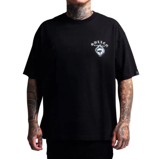 A man wearing a black short-sleeve t-shirt with a small white chest graphic that reads 'SULLEN' and features a stylized skull logo. The model has visible tattoos on his neck and arms, and is photographed against a solid white background.