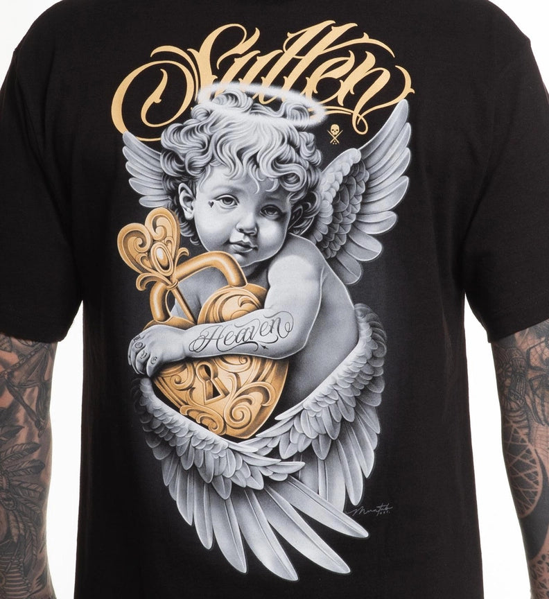 Load image into Gallery viewer, A close-up of a black graphic t-shirt featuring a detailed illustration of a cherub with wings holding a gold heart, with the word 'Sullen' in gold script above.
