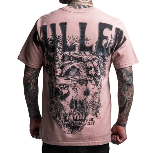Person wearing a pink t-shirt with a black skull design on the back