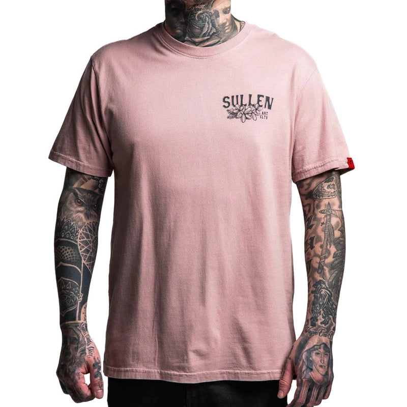 Load image into Gallery viewer, Person wearing a pink t-shirt with 'Sullen' logo and tattoos on arms, neck, and hands.
