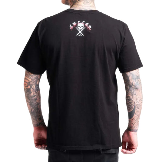 A man wearing a black short-sleeve t-shirt, viewed from the back. The shirt features a small graphic print on the upper back with a skull, crossed tools, and red and white details.