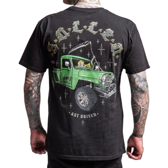 Black t-shirt with a green truck graphic on the back, worn by a person with tattoos.