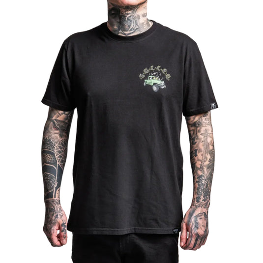 Person wearing a black t-shirt with a green graphic on a white background
