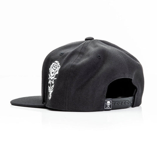 Black cap with an embroidered white rose design on a white background