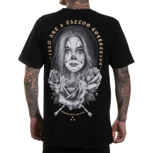 Black t-shirt with a graphic design of a woman's face surrounded by roses and text on the back, worn by a person.