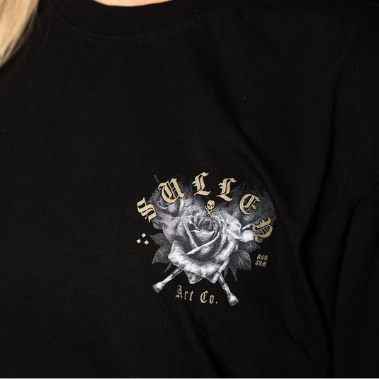 Close-up of a person wearing a black crewneck sweatshirt with a graphic on the chest featuring a grayscale rose and the text 'SULLEN Art Co.' in a stylized font.