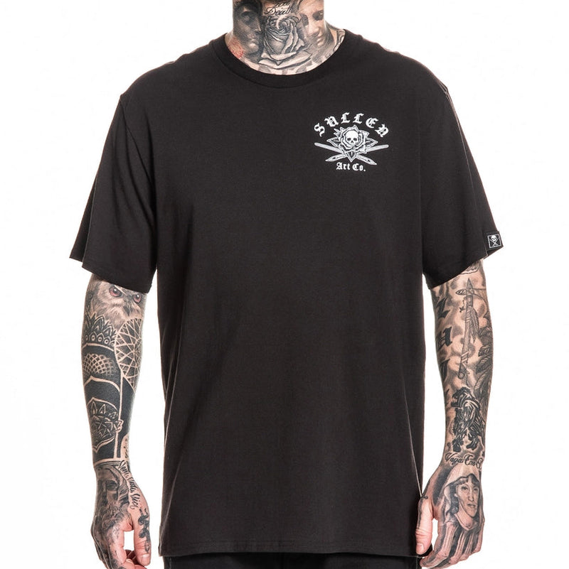Load image into Gallery viewer, Person wearing a black t-shirt with a Sullen logo on a white background
