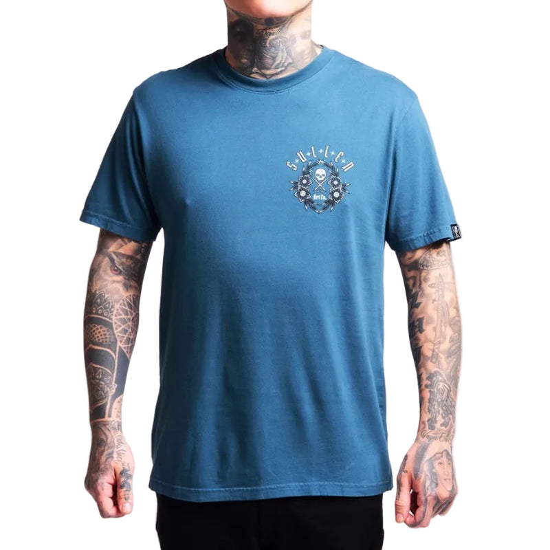 Load image into Gallery viewer, Person wearing a blue t-shirt with a logo on a plain background
