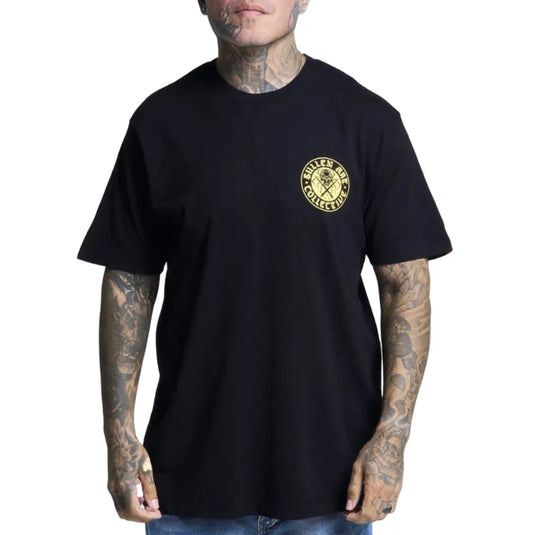 A man wearing a black short-sleeve t-shirt with a circular gold graphic on the left chest that reads 'SULLEN ART' and 'COLLECTIVE'. The photo is taken against a solid white background.