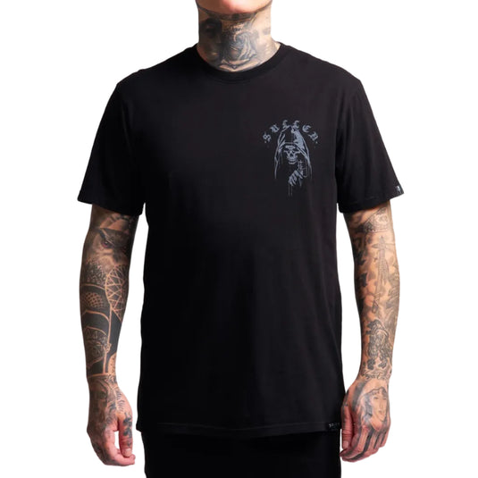 A man wearing a black short-sleeve t-shirt with a gray graphic print on the left chest. The graphic features a hooded figure and the word 'SULLEN' in a gothic font.