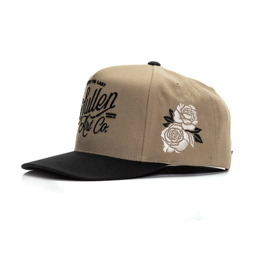 Beige and black cap with floral design and text on a white background