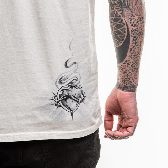 Person wearing a white t-shirt with a black graphic design on a white background