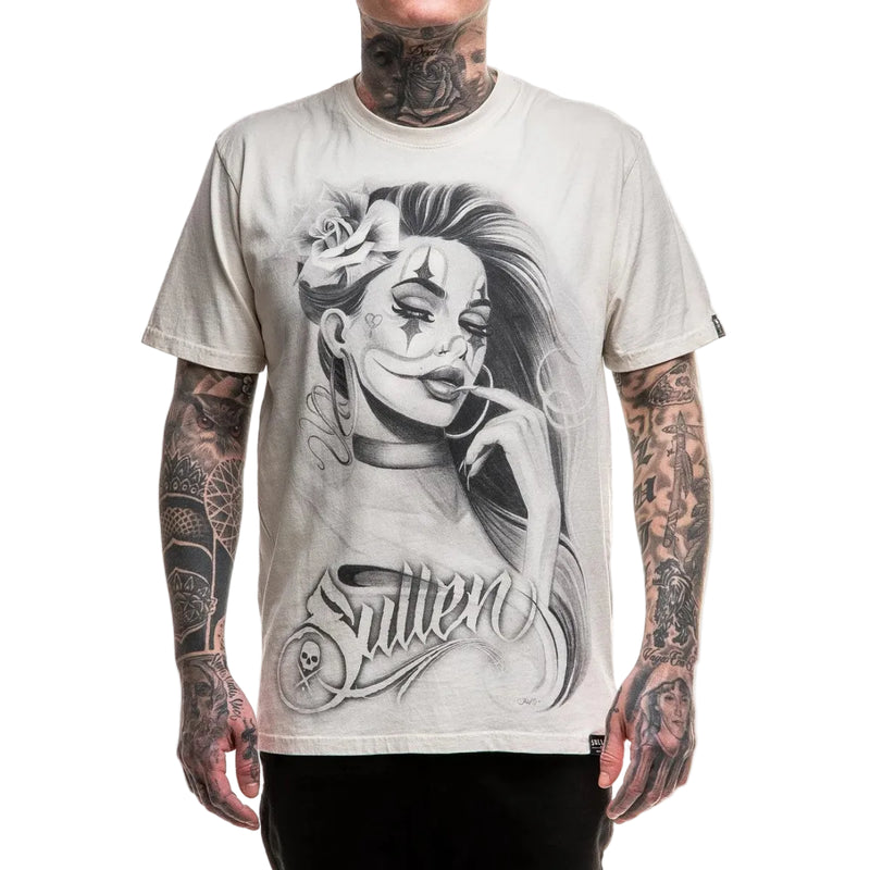 Load image into Gallery viewer, A man wearing a light beige graphic t-shirt with a black and white illustration of a woman's face and the word 'Sullen' printed on the front, set against a plain white background.
