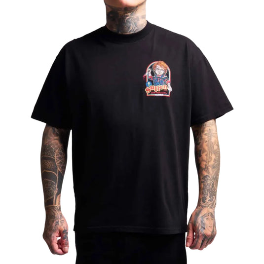 A man wearing a black crewneck t-shirt with a colorful graphic print of Chucky on the left chest, set against a plain white background.