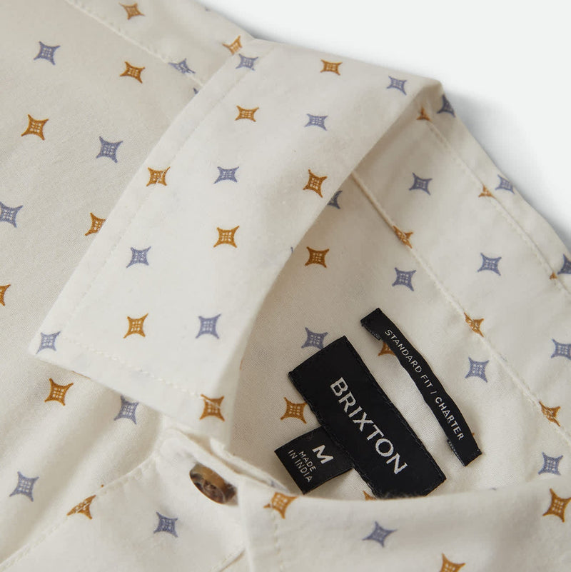 Load image into Gallery viewer, Close-up of a multi-color diamond patterned shirt with Brixton inner label, buttons, and collar
