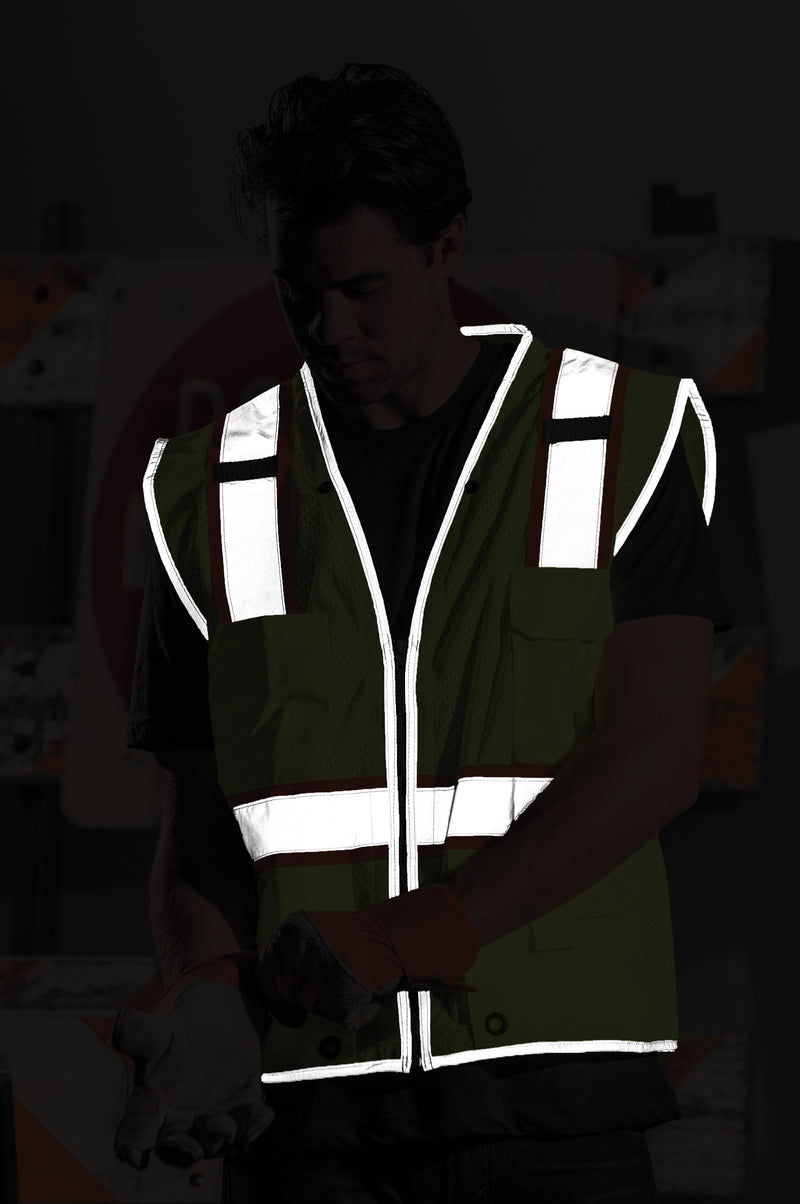 Load image into Gallery viewer, Visual of reflective stipe at night with a person wearing the lime colored Kishigo 1510 vest.
