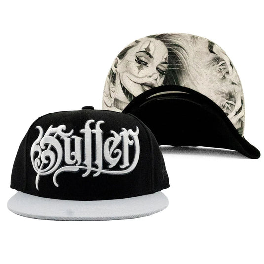 A black flat-brim snapback cap with a white embroidered gothic 'Sullen' logo on the front, shown alongside a second view of the cap from the back displaying a black and white clown face graphic on the brim.